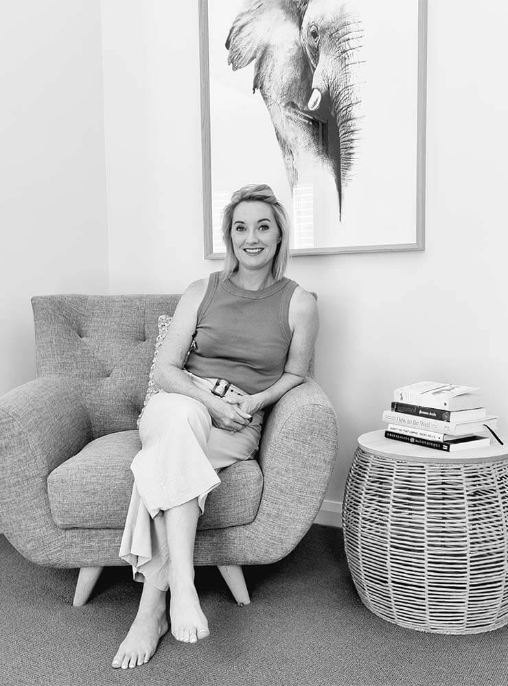 Dani O'Brien sitting on a chair at her Soul Holistic Counselling practice in Deniliquin.